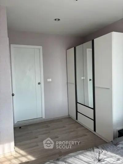 Modern bedroom with sleek wardrobe and minimalist design