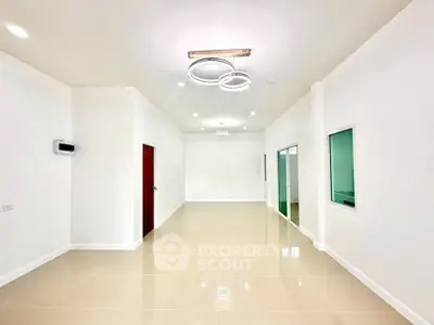 Spacious modern living room with elegant lighting and glossy tiled flooring