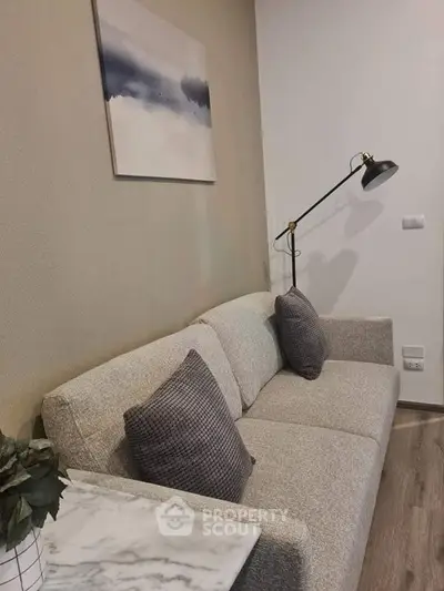 Cozy living room with modern sofa and stylish floor lamp, perfect for relaxation.