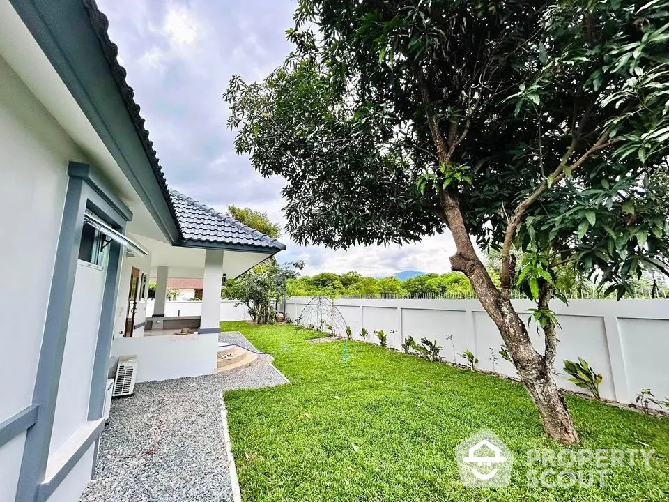 Charming house with lush garden and spacious lawn, perfect for outdoor relaxation and family gatherings.