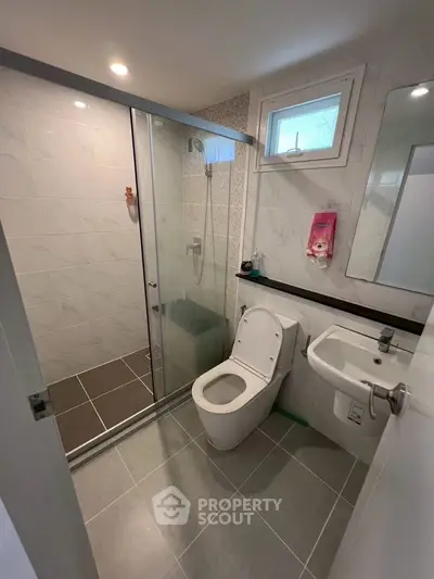 Modern bathroom with glass shower and sleek fixtures