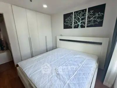 Modern bedroom with white furniture and elegant wall art