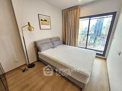 Modern bedroom with city view and stylish decor in high-rise apartment