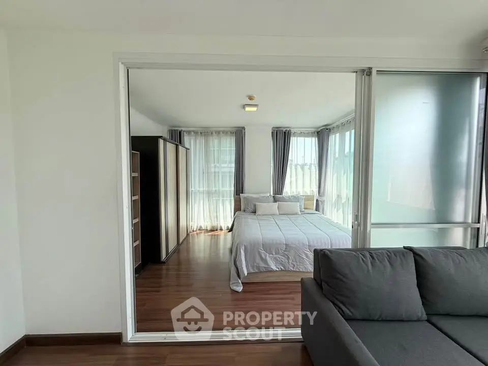 Spacious bedroom with sliding glass doors and modern decor