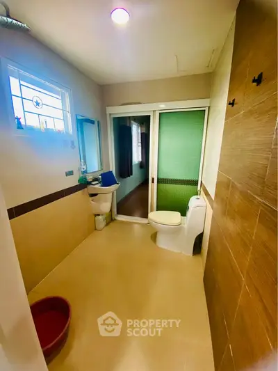 Spacious bathroom with modern fixtures and sliding door design