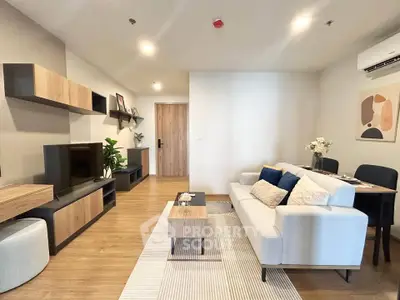 Modern living room with stylish furniture and wooden flooring in a cozy apartment.