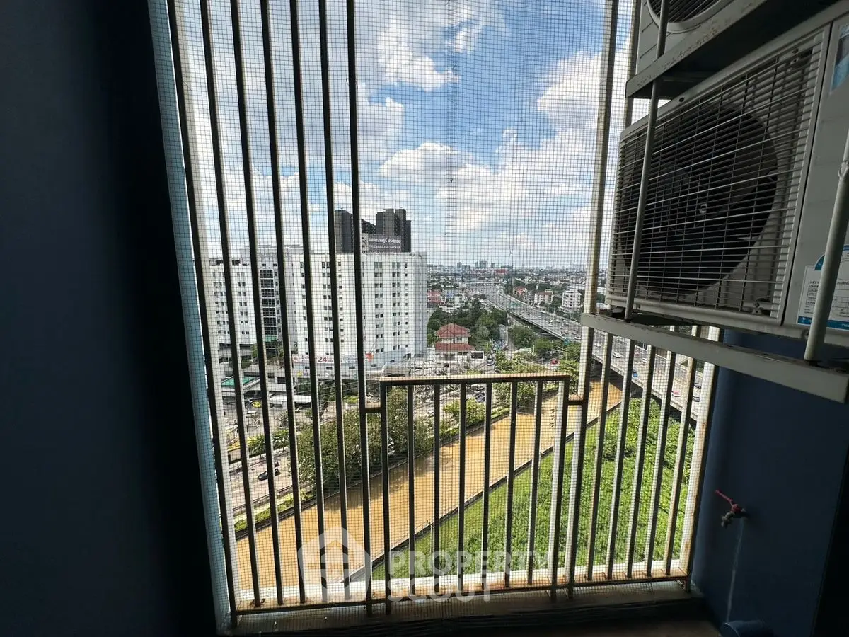 Stunning cityscape view from a high-rise balcony with modern railing.