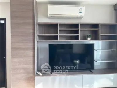 Modern living room with sleek TV unit and air conditioning