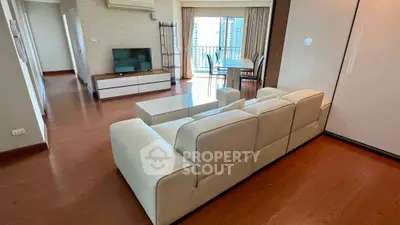 Spacious living room with modern furniture and balcony view in a stylish apartment.