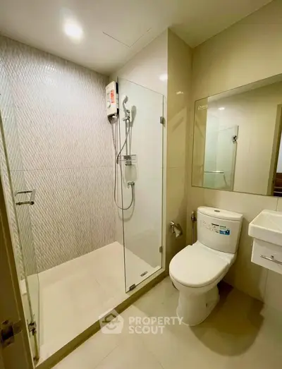 Modern bathroom with glass shower enclosure and sleek fixtures