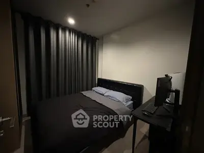 Cozy bedroom with dark curtains and modern computer setup
