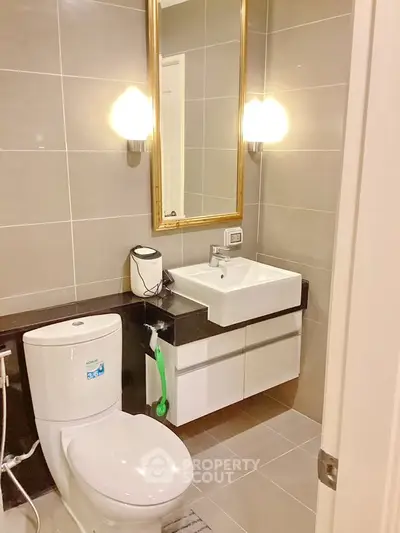 Modern bathroom with sleek fixtures and elegant lighting in a contemporary apartment.