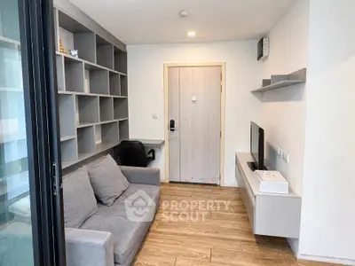 Modern living room with sleek shelving and cozy gray sofa