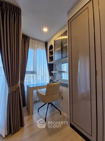 Modern study room with elegant desk and chair, large window with curtains, and built-in storage.