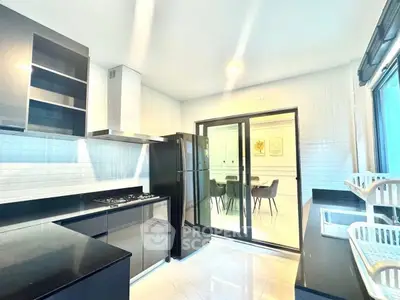 Modern kitchen with sleek black appliances and open layout design