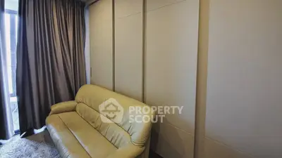 Cozy living room with modern sofa and floor-to-ceiling curtains