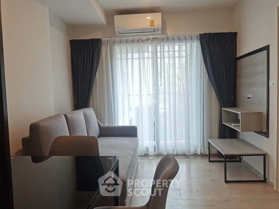 Modern living room with sleek furniture and large window for natural light