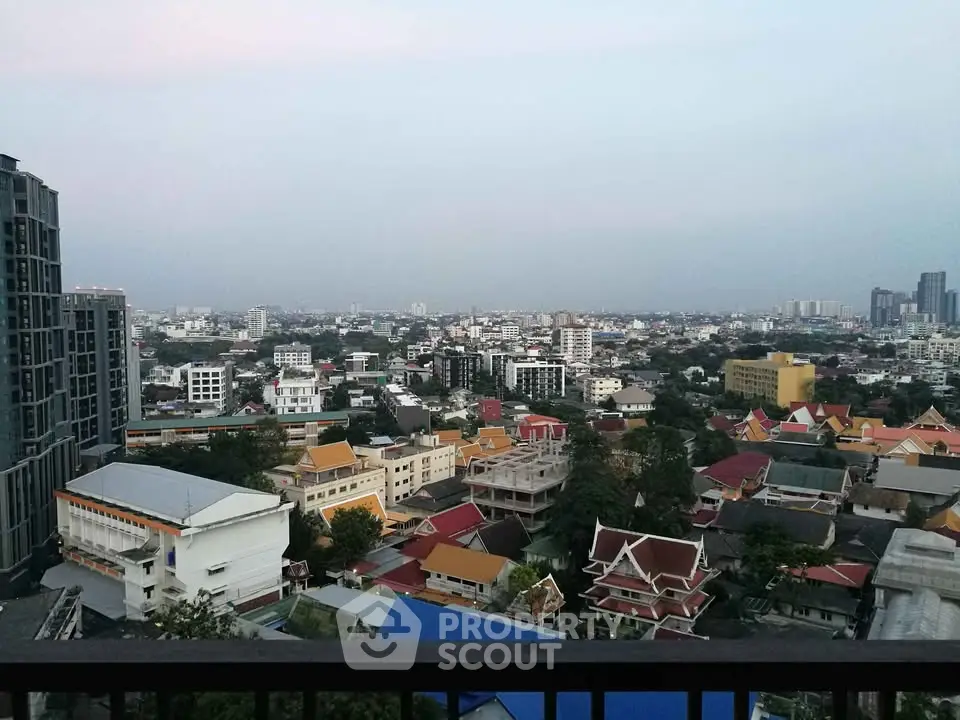 Stunning cityscape view from a high-rise balcony showcasing urban skyline and vibrant architecture.