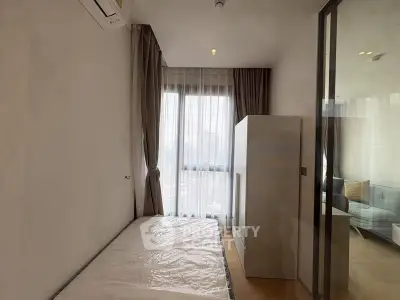 Cozy minimalist bedroom with large window and natural light