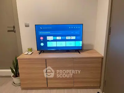 Modern living room with sleek TV setup and stylish wooden cabinet