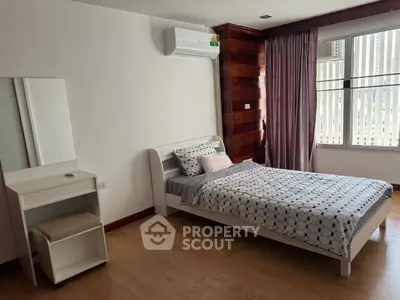 Cozy bedroom with modern decor and ample natural light