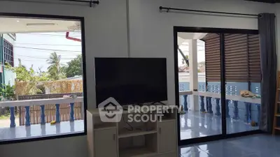 Spacious living room with large windows and balcony access