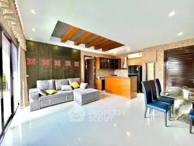 Spacious open-plan living room with modern kitchen and stylish decor