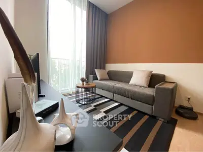 Modern living room with stylish decor and large window for natural light.
