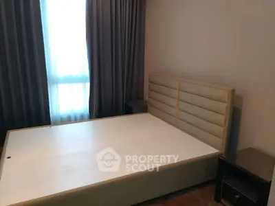 Spacious bedroom with modern bed frame and natural light
