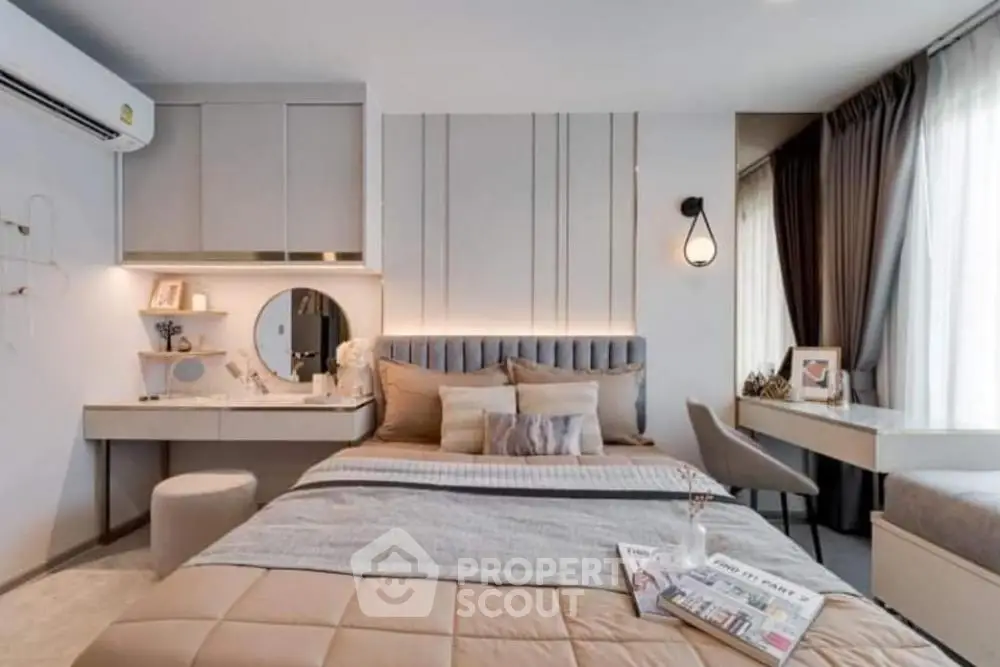 Modern bedroom with stylish decor and natural light, featuring a cozy bed and elegant furnishings.