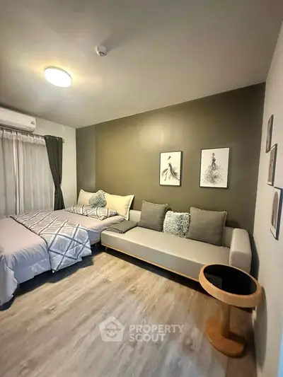 Modern bedroom with stylish decor and cozy seating area, perfect for relaxation.