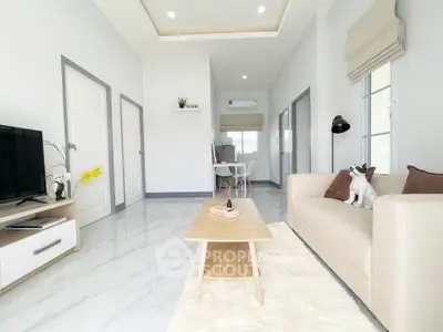 Bright and modern living room with stylish decor and cozy ambiance.