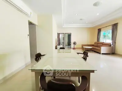Spacious living room with modern furniture and large windows for natural light.