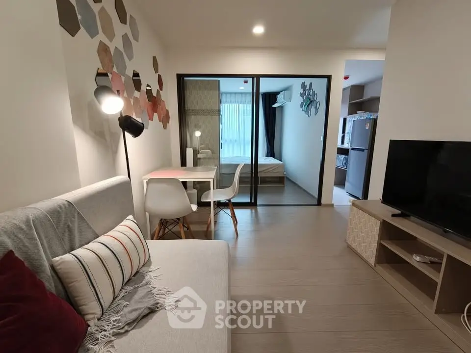 Modern living room with stylish decor and open view to bedroom