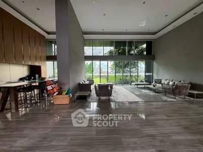Spacious modern living room with floor-to-ceiling windows and garden view.