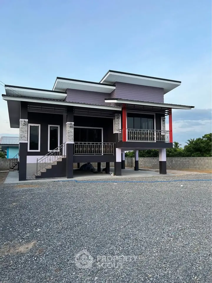 Modern two-story house with unique architectural design and spacious driveway