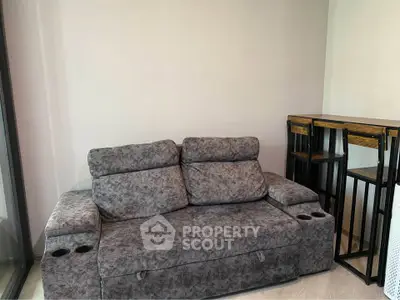Cozy living room with plush gray sofa and stylish bar table set, perfect for modern living.