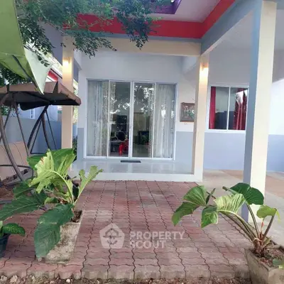 Charming single-story home with inviting patio and lush greenery, perfect for relaxation and outdoor enjoyment.
