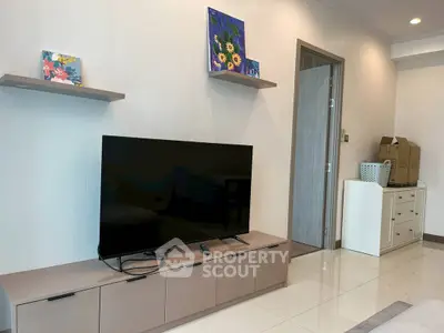 Modern living room with sleek TV stand and wall art, showcasing contemporary interior design.