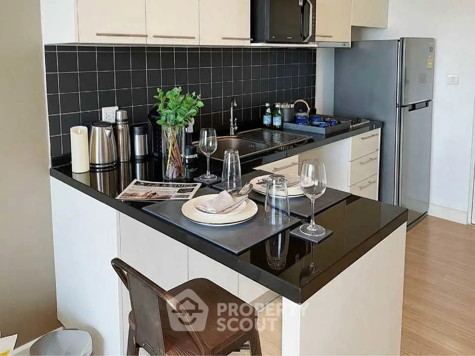 Modern kitchen with sleek black countertops and stainless steel appliances