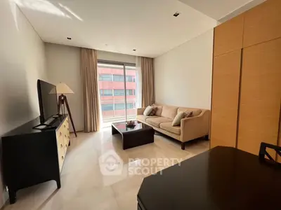 Modern living room with natural light, stylish furniture, and a city view, perfect for urban living.