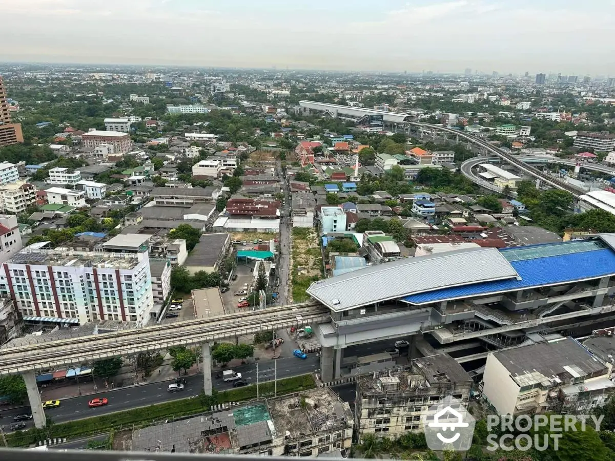 Stunning aerial view of urban landscape with modern transit system and residential buildings.