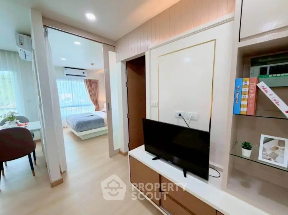 Modern apartment interior with open living area and cozy bedroom view.