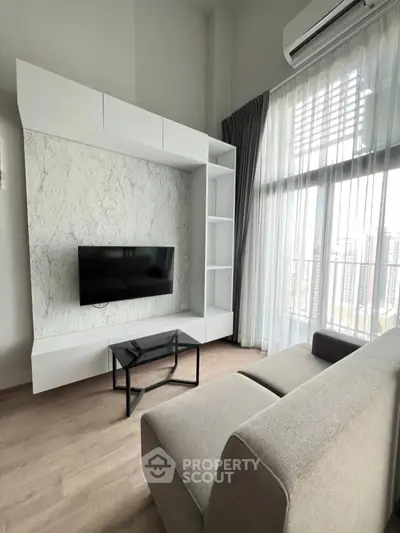 Modern living room with sleek TV unit and large window view