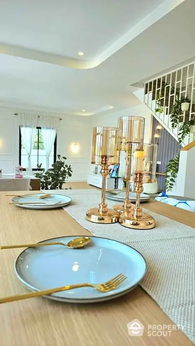 Elegant dining area with modern decor and stylish table setting in a bright open space.