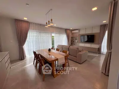 Spacious modern living room with elegant dining area and large windows.