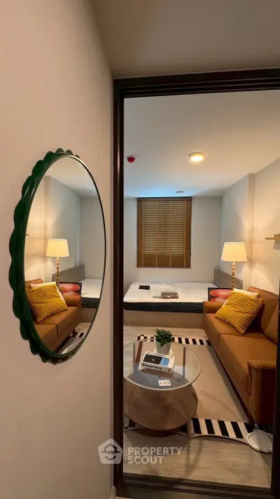 Cozy living room with modern decor and stylish furniture, featuring a comfortable sofa and elegant lighting.
