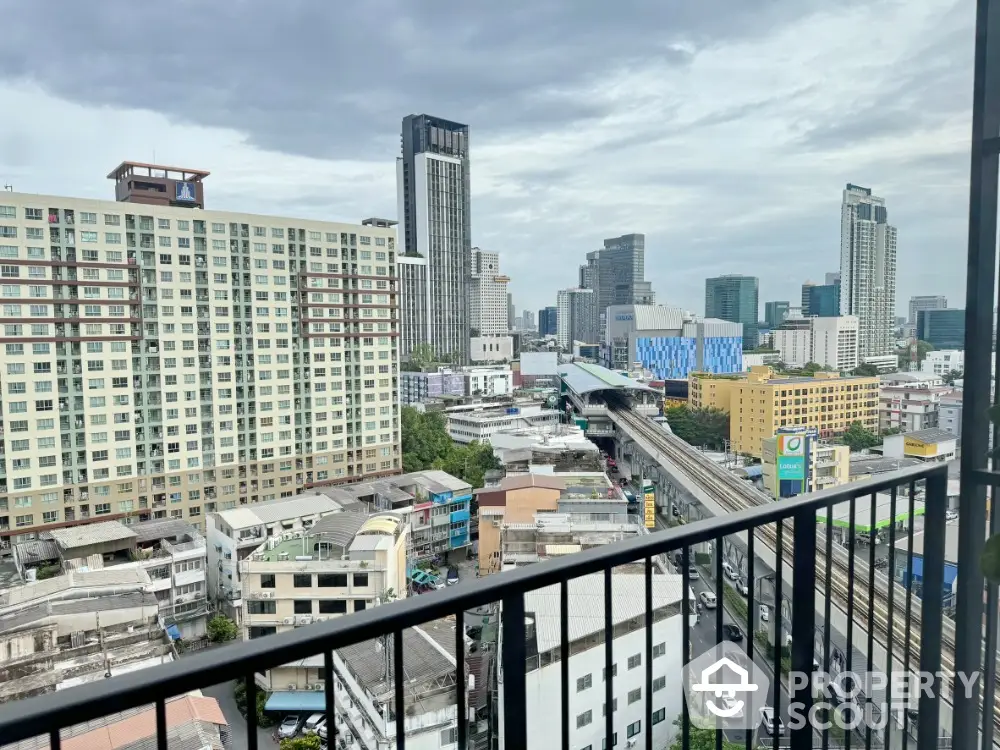 Stunning cityscape view from a high-rise balcony overlooking urban skyline and bustling streets.