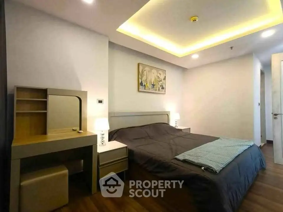 Modern bedroom with stylish decor and cozy lighting in a contemporary apartment.