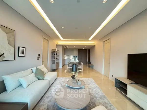 Luxurious modern living room with elegant decor and open kitchen layout.